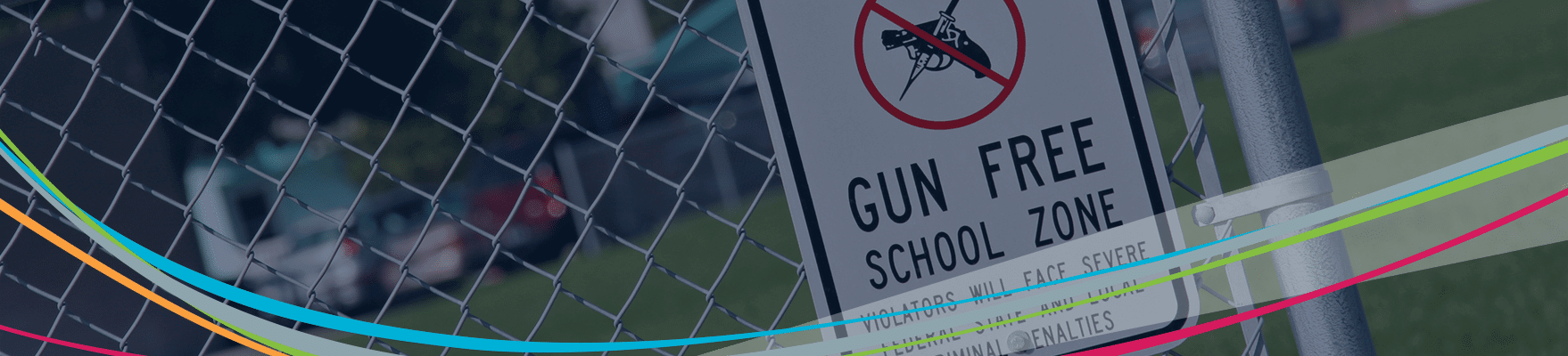 Gun free zone sign on fence School violence prevention header