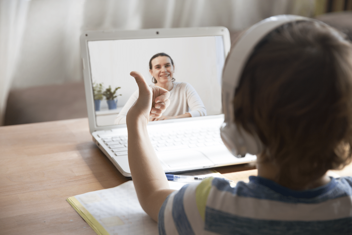 Kid giving thumbs up on Zoom call