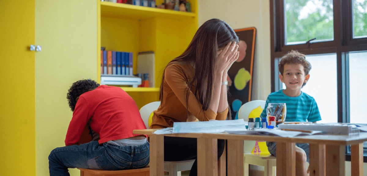 Strategies to improve student and teacher mental health girl with hands over face